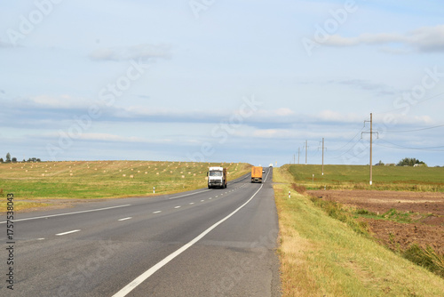 Countryside landscape. Road with trucks.