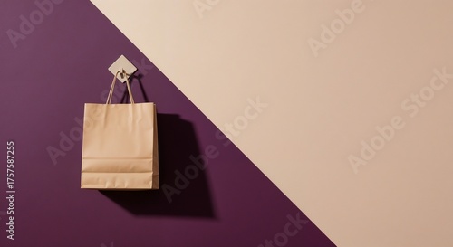 Minimalist paper shopping bag on a geometric hook. Modern retail concept with purple and beige background. Ample copy space for design