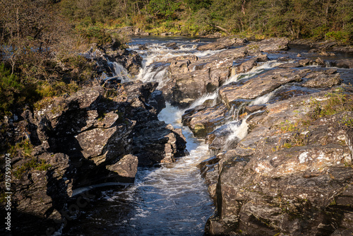 A bright autumnal HDR image of Eas Urchaidh waterfall in Glen Orchy, on its way to Loch Awe, Argyle and Bute, Scotland. 