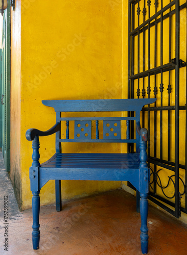 Blue Wooden Chair in Yellow Wall Corner.