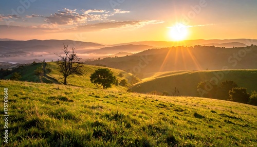 Rolling green hills bathed in golden sunlight at sunrise, with misty valleys and distant mountains