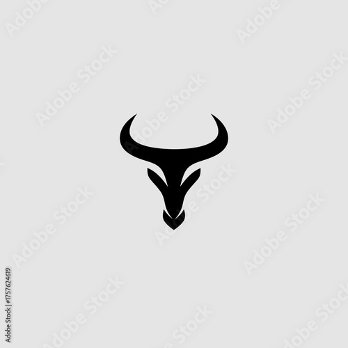 Minimalist abstract black bull head silhouette vector icon representing power, strength, and determination on a light gray background.