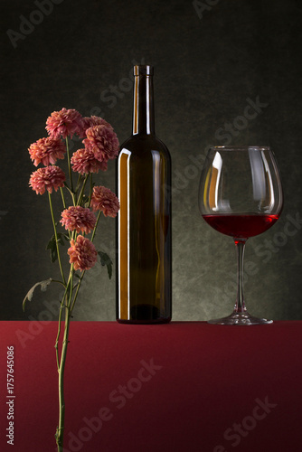 Still life with flowers, a bottle and a glass of wine