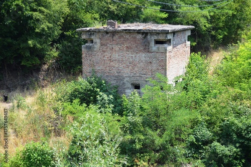 an old brick bunker overgrown with plants