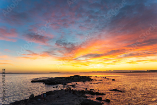 Dazzling sunset from Tabarca Island with Santa Pola in front in Alicante, Spain