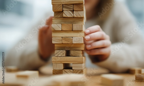 Stacking Wooden Blocks During a Game With Friends in a Cozy Indoor Setting
