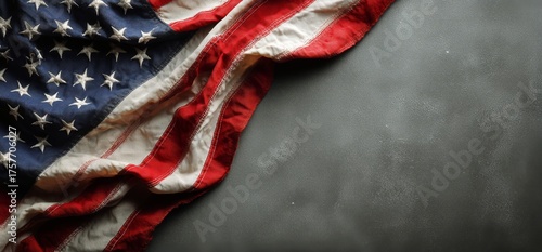 Waving American Flag Drapes Over a Dark Surface in a Display of National Prid...