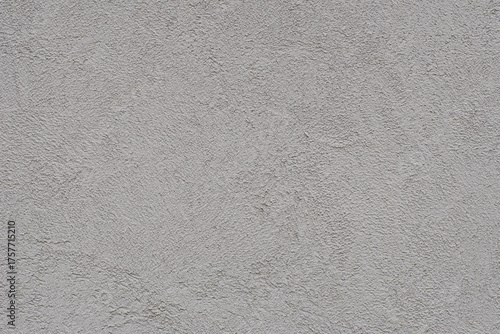 刷毛の模様が美しいコンクリートの壁のクローズアップ。灰色でざらざらした質感の背景