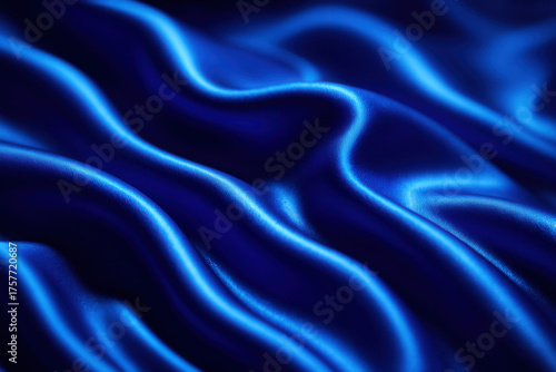 Luxurious Deep Blue Satin Fabric Featuring Smooth Wavy Folds and Glossy Luminous Highlights