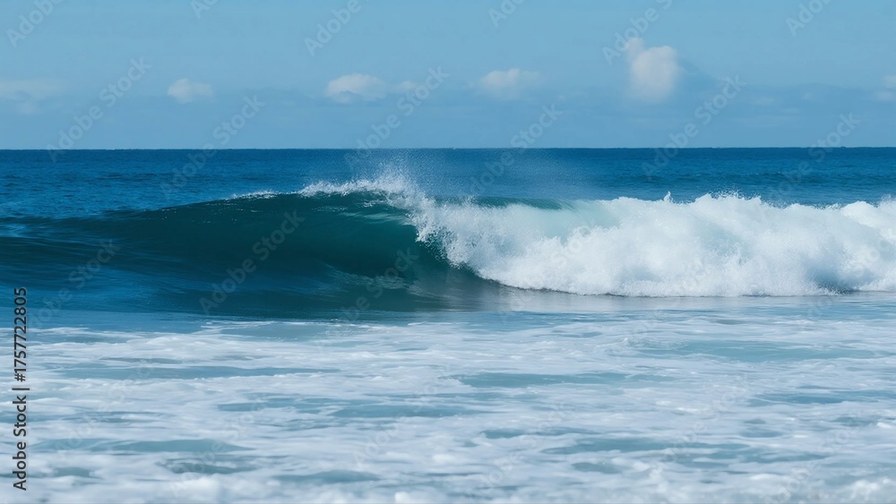 Fototapeta premium A stunning ocean wave is seen rolling in, with clear blue sky in the background, showcasing the beauty of the sea.