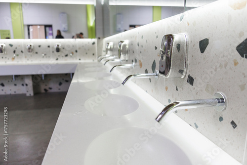 Modern Public Restroom Sinks with Wall-Mounted Faucets and Terrazzo Counter