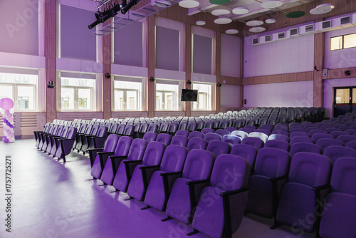 Empty Modern Auditorium with Purple Seating and Stage