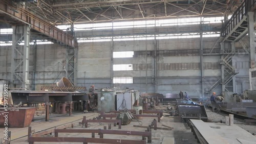 Wallpaper Mural A large shipyard or steel structure factory from the inside. Huge workshop for assembling steel structures and steel bridges. Fabrication of steel structures. Industrial interior. Manufacturing plant Torontodigital.ca