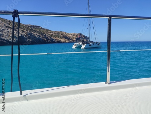 View from Yacht Railing towards Sailboat on Blue Mediterranean Sea.
