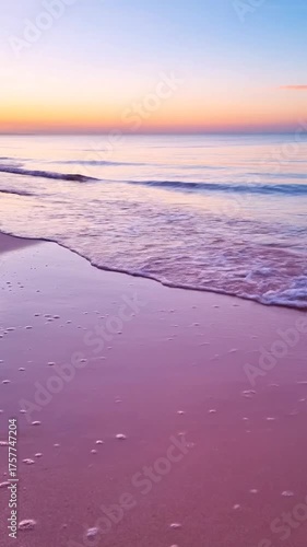 Tranquil coastal scene gentle waves kissing sandy shore at sunset
