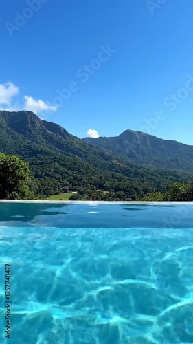 Tranquil outdoor swimming pool with clear water and distant mountain range