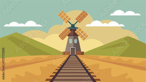 A lone windmill stands tall against the backdrop of the railway a nod to the slower simpler way of life in the countryside.