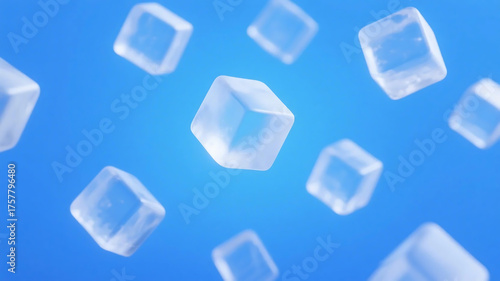 Transparent cubic ice cubes floating against a clear blue background, showcasing their cool and refreshing appearance.