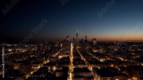 Panoramic aerial drone footage captures the vibrant urban sprawl of a major city skyline transitioning from twilight to deep night with a clear