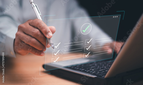 Digital checklist and task management concept. Businessman using pen marking completed items on a virtual screen. Productivity, project planning, workflow optimization and online business efficiency.