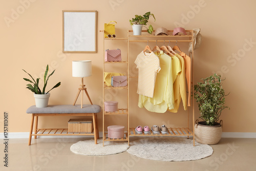 Rack with stylish clothes, ...