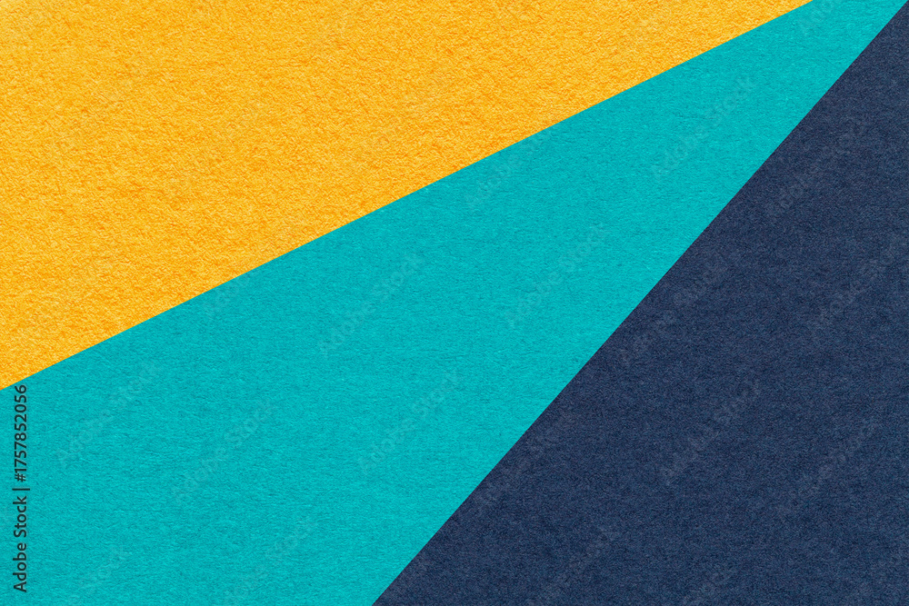 Fototapeta premium Abstract old geometric paper background with yellow, turquoise, navy blue rays, macro texture for banner, template