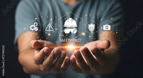 Safety First Concept: Man Presenting Workplace Safety Icons in His Hands