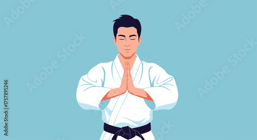 Martial artist in a white gi with a black belt stands with hands pressed together in a respectful stance.