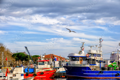 Erdek, Turkey - February 8, 2024 : Erdek Town harbor with ships at sunset