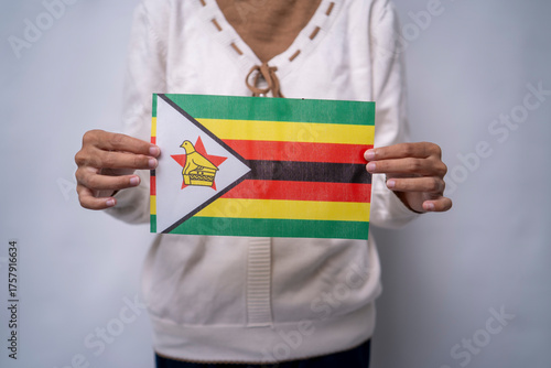 Person holding the national flag of Zimbabwe