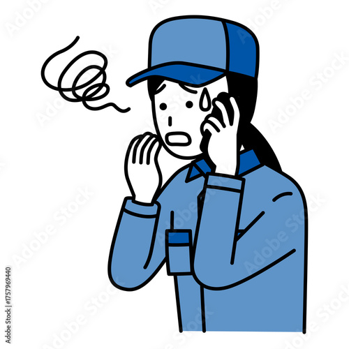 スマートフォンでの通話で困惑するつなぎ作業服の女性