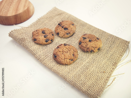 Chocolate Chip Cookies on Wooden Cutting Board Over Burlap Fabric Background