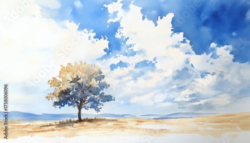 Lonely tree standing in a field under a bright blue sky with fluffy white clouds