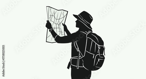 Silhouette of a female traveler looking at a map
