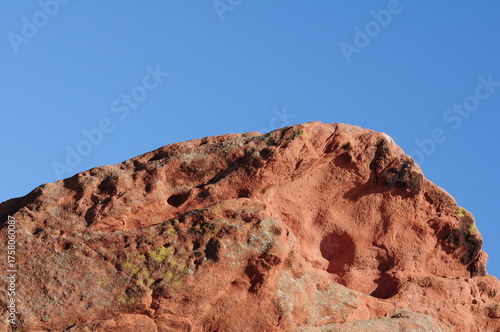 Red rocks and sandstone formations create a dramatic desert canyon landscape in the American Southwest