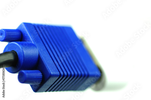 Close-up macro shot of a metal tool and blue data cable near computer electronic equipment