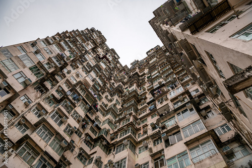 Canvas Print View of the mottled exterior of crowded narrow apartments in a residential tower