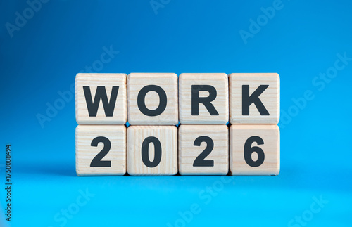 New year Work 2026 concept. Wooden cubes on a blue background