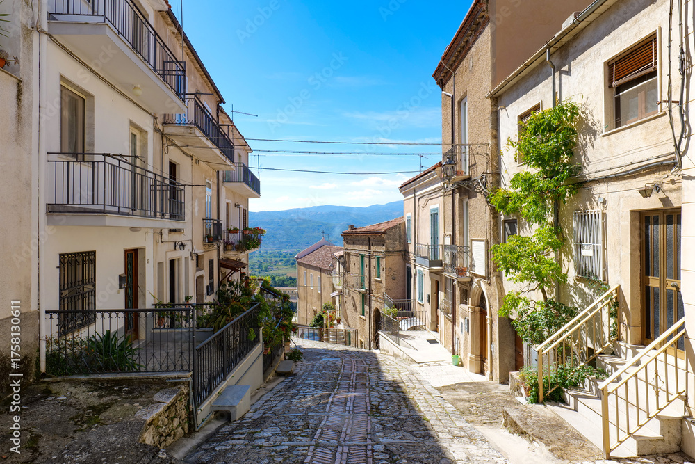 Fototapeta premium A narrow street among the old houses of Padula, a village in the province of Salerno, Italy.