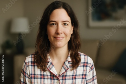 Smiling woman in pajamas looking at the camera in a cozy home setting Free Download Smiling woman in pajamas looking at the camera in a cozy home setting - GFXLoad