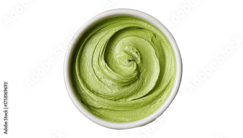 Overhead view of a circular white bowl filled with creamy, swirled, pale-green food