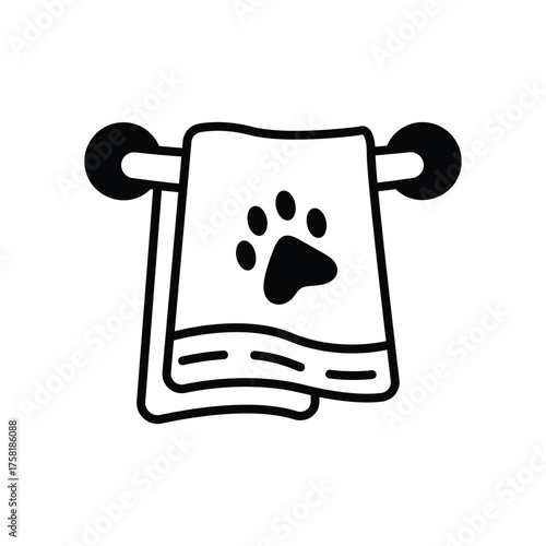 A towel with a paw print hangs on a black towel rack