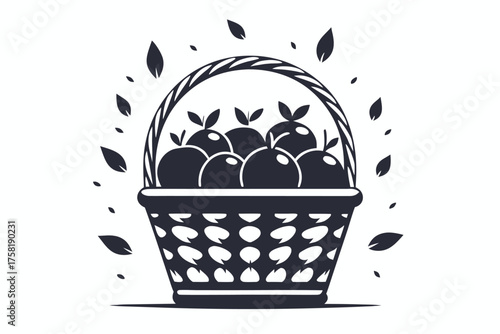 Basket filled with apples and few leaves around in black and white