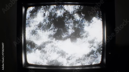 Watery reflection on a vintage screen, framed in darkness