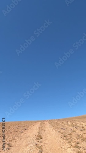 Driving along a country road in Altai desert and semi-desert environment.