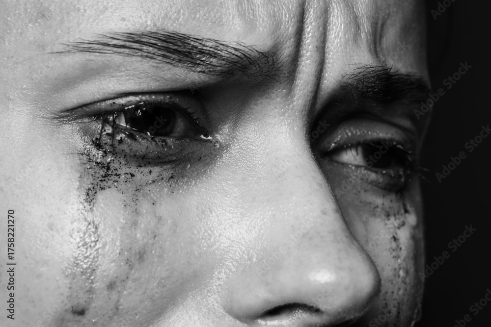 Naklejka premium Sad woman crying on dark background, closeup. Black and white effect