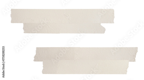 photograph of two layered horizontal strips of beige masking tape isolated on black, showing ripped paper texture and rough edges.