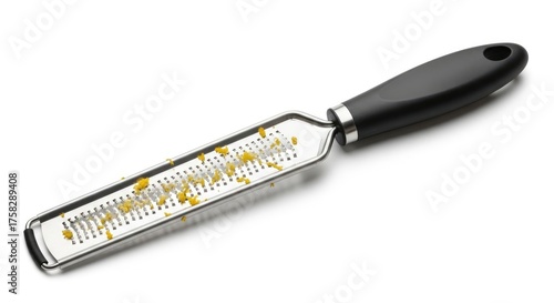 Stainless steel microplane grater with fresh lemon zest, isolated on a white background.