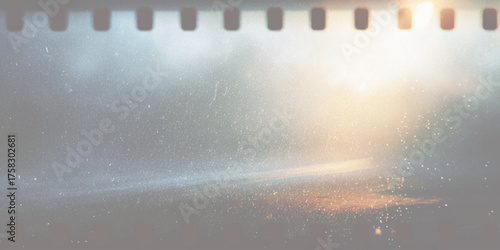 Faded film strip with light flares and dust perforations