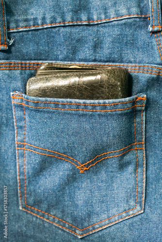 Close up of leather wallet in jeans pocket